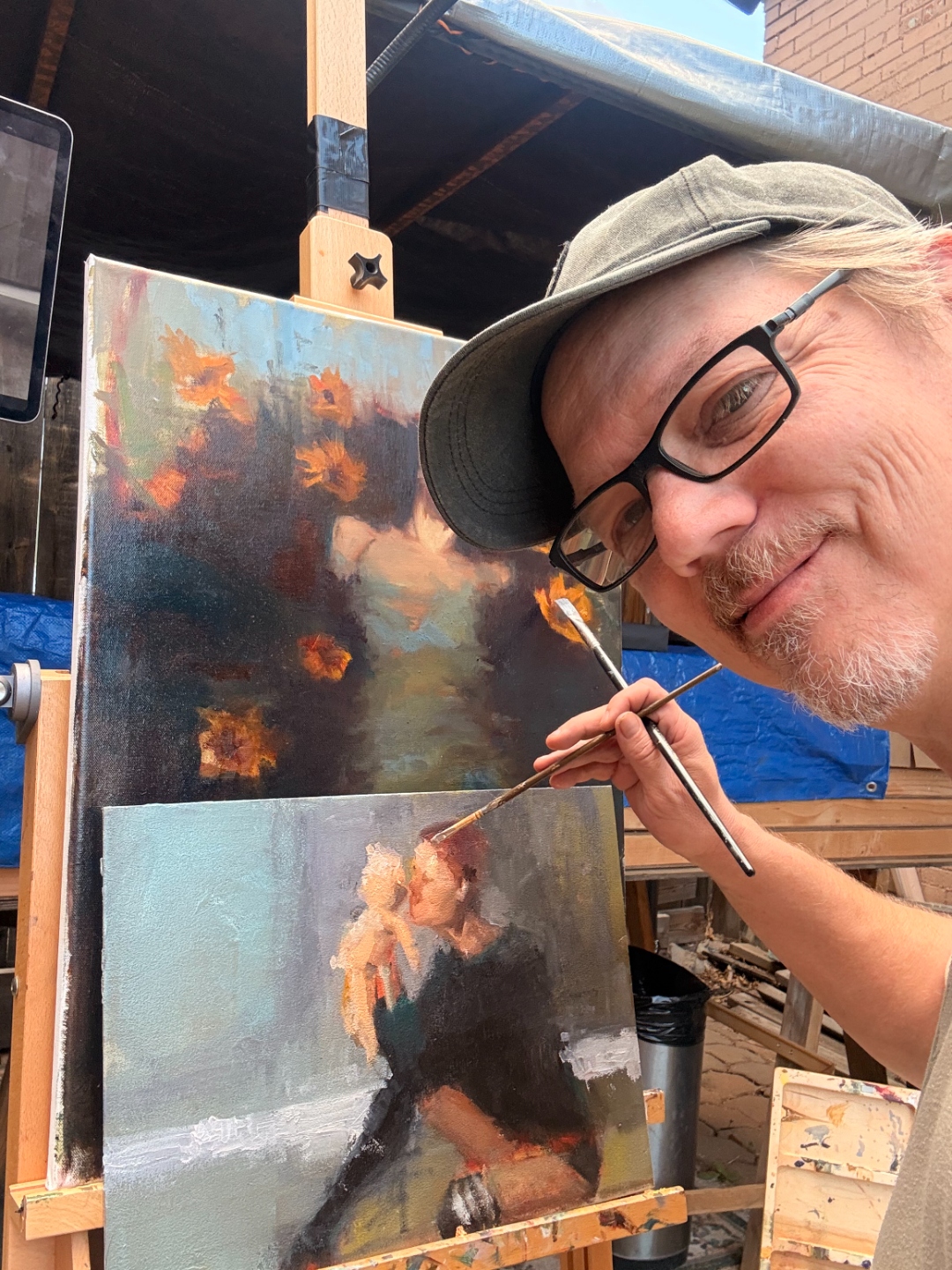 Close-up process shot — Chad painting the Ophelia canvas outdoors