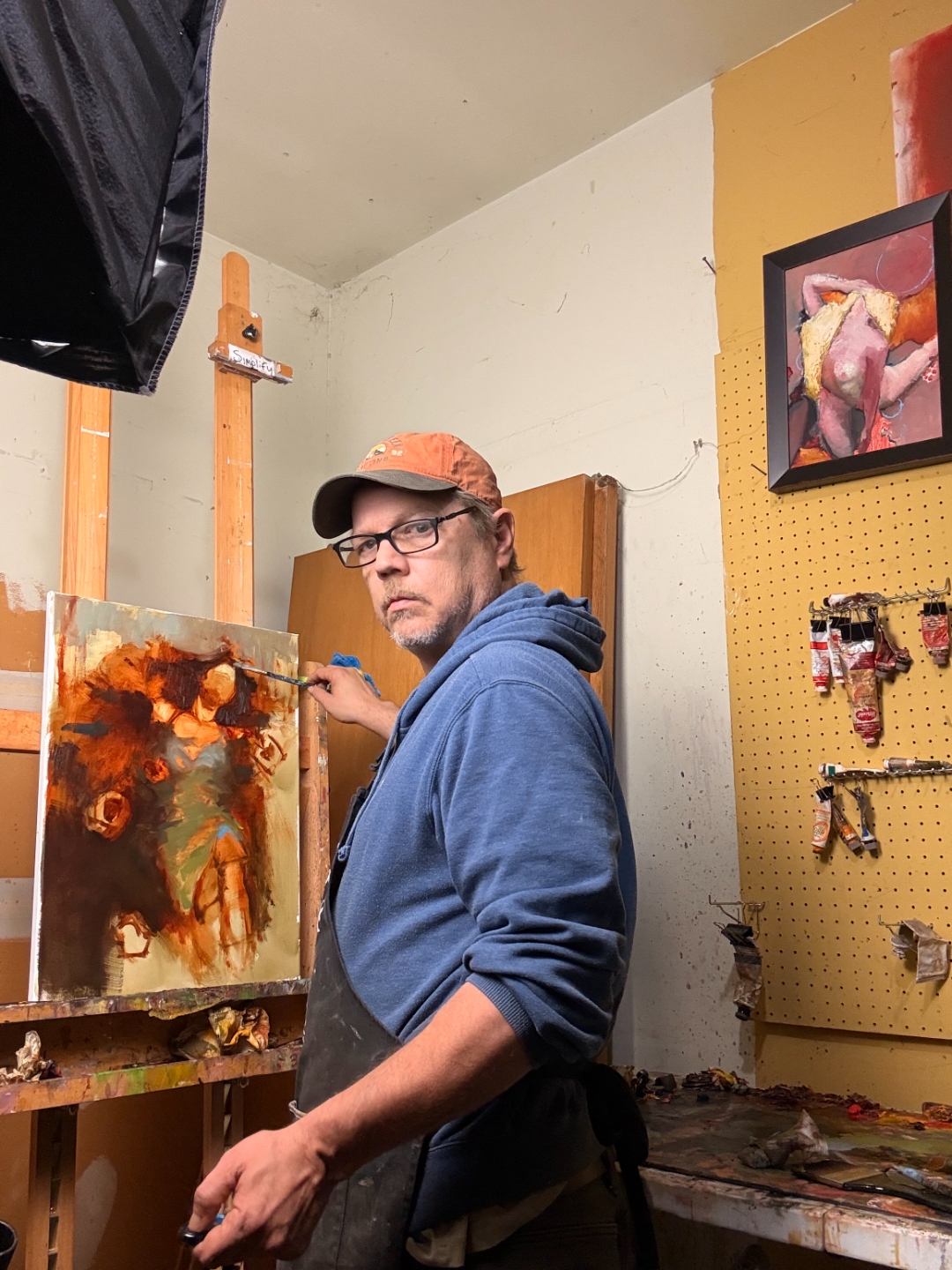 Chad in the studio working on another piece, Ophelia canvas visible